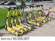 Moscow, Russia - Apr 26. 2024. Short-term rental service for electric scooters Yandex Go and Urent in Zelenograd. Редакционное фото, фотограф Володина Ольга / Фотобанк Лори