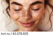 Beautiful young girl with gorgeous dark thick eyebrows, freckles on her face. Skin care, sunscreen cosmetics, eyebrow care concept. Стоковое AI-изображение, AI-художник Ольга Яковенко / Фотобанк Лори