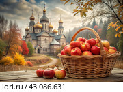 The concept of the Russian Orthodox holiday yablochny spas. A beautiful wicker basket made of vines with red ripe apples on the background of an Orthodox church. Стоковое AI-изображение, AI-художник Photojuli / Фотобанк Лори