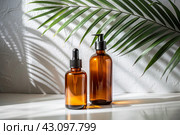 Aromatherapy. A glass bottle with a pipette for oil, lotion and palm leaves on a concrete background. Natural organic eco-cosmetics. The layout of the corporate identity of the beauty salon. Стоковое AI-изображение, AI-художник Photojuli / Фотобанк Лори
