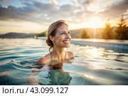 A beautiful young woman is swimming and exercising in a heated pool, a happy and smiling girl. Recreational water sports. Стоковое AI-изображение, AI-художник Photojuli / Фотобанк Лори