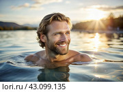 A handsome young man is swimming and practicing in a heated pool, a happy and smiling girl. Recreational water sports. Стоковое AI-изображение, AI-художник Photojuli / Фотобанк Лори