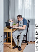 Presbyopia is an age related visual impairment, 52 year old man trying to read text on laptop screen. Стоковое фото, фотограф Владимир Григорьев / Фотобанк Лори