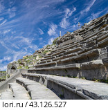 West Theatre of Umm Qais (Umm Qays)--is a town in northern Jordan near the site of the ancient town of Gadara, Jordan. Against the background of a beautiful sky with clouds (2016 год). Стоковое фото, фотограф Владимир Журавлев / Фотобанк Лори