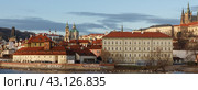 Praque, Czech Republic - February 1, 2013: Franz Kafka Museum area. View of the downtown. Tilerd red roofs of the buildings. Sunny day. Chapel of St. Theresa. Panorama. Редакционное фото, фотограф YuryKara / Фотобанк Лори