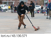 Moscow, Russia - October 2, 2021: Successful push scooter stunt on the street in autumn day. Boy did the trick. Street Jam. He didn't fell. Extreme sports is popular among youth. Редакционное фото, фотограф YuryKara / Фотобанк Лори