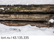 Winter rustic background of snow-covered wooden logs. Стоковое фото, фотограф Iva Noel / Фотобанк Лори