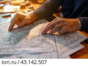 An astrologer compiles and studies a natal chart for his client, astrology, astrological signs. Стоковое AI-изображение, AI-художник Ольга Ильина / Фотобанк Лори