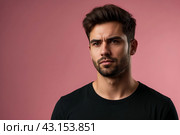 Dissatisfied young man looking unpleasantly away, expresses aversion, smirking at pink background. Guy in black t-shirt scared, negative face expressions concept. Advertising. Copy text space. Стоковое AI-изображение, AI-художник Aleksandr Golubev / Фотобанк Лори