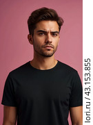 Dissatisfied young man looking unpleasantly away, expresses aversion, smirking at pink background. Guy in black t-shirt scared, negative face expressions concept. Advertising. Copy text space. Стоковое AI-изображение, AI-художник Aleksandr Golubev / Фотобанк Лори