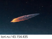 a burning comet , an asteroid flying in the sky. Стоковое фото, фотограф Андрей Знаменский / Фотобанк Лори