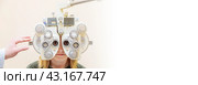 Phoropter eye test for a girl in an eye clinic. Стоковое фото, фотограф Юрий Поздников / Фотобанк Лори