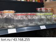 Neatly organized labeled food pantry in a home kitchen with spices grains flour rice sugar nuts. Стоковое фото, фотограф Вербицкая Светлана / Фотобанк Лори