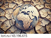 The concept of global warming of the planet earth. Dry and cracked earth, dry due to lack of rain. The effects of climate change. Стоковое AI-изображение, AI-художник Photojuli / Фотобанк Лори