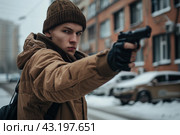 Student in a hat walking with a gun on the background of the high school, school shootings concept, school violence. Стоковое AI-изображение, AI-художник Anastacia Gaikova / Фотобанк Лори