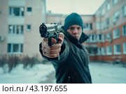 Student in a black hat walking with a gun on the background of the high school, school shootings concept, school violence. Стоковое AI-изображение, AI-художник Anastacia Gaikova / Фотобанк Лори