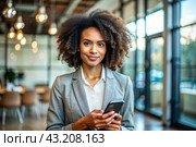 A businesslike dark-skinned African-American woman with curly hair. She is dressed in a casual jacket. In the hands of a smartphone. A businesswoman looks at her mobile phone. Стоковое AI-изображение, AI-художник Photojuli / Фотобанк Лори