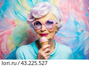 Portrait of an extraordinary, stylish, fashionable elderly woman, a pensioner of 70 years old, with glasses and ice cream in her hand. The concept of happy seniors and delicious desserts. Стоковое AI-изображение, AI-художник Photojuli / Фотобанк Лори