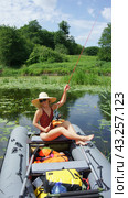 A girl with a fishing rod in her hands. Girl on fishing. A girl in a boat catches fish. (2010 год). Редакционное фото, фотограф Zima Nadezhda / Фотобанк Лори