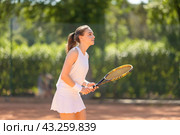 A woman is playing tennis on a court. Стоковое фото, фотограф Константин Шишкин / Фотобанк Лори