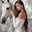 A beautiful young girl in an open white outfit holds the bridle and presses the head of a white horse to her. Close-up. Generated by AI. Стоковое AI-изображение, AI-художник Ярославский Максим / Фотобанк Лори