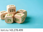 Кубики со знаками процентов на голубом фоне. Экономика, налоги, бизнес, финансы, скидки. Стоковое AI-изображение, AI-художник Щеголева Ольга / Фотобанк Лори