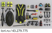A complete set of triathlon gear and accessories neatly arranged around the bike. In the center is a modern racing bicycle, surrounded by equipment such as a cycling suit, helmet, goggles, gloves, shoes and various tools. Each piece comes in vibrant neon and black colors to highlight its sporty and dynamic character. All elements are arranged symmetrically, creating an organized and aesthetically pleasing composition. The image is ideal for a stock site dedicated to triathlon, cycling and active lifestyle. Стоковое AI-изображение, AI-художник Анна Кривицкая / Фотобанк Лори