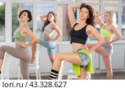 Putting foot hand on seat of chair, girl improvises, perform lap dance during group master class. Стоковое фото, фотограф Яков Филимонов / Фотобанк Лори