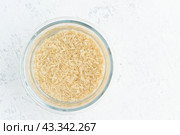 Soaking brown rice cereal in water to ferment cereals and neutralize phytic acid. Стоковое фото, фотограф Natalia Gdovskaia / Фотобанк Лори