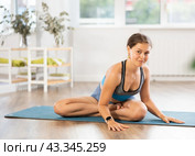 Young woman practicing vinyasa yoga in studio. Стоковое фото, фотограф Яков Филимонов / Фотобанк Лори