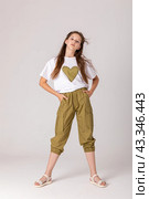 High fashion look. Glamor stylish beautiful young student girl model in summer trousers and white shirt on white background. Copy space. Mock up. Стоковое фото, фотограф Ирина Михайличенко / Фотобанк Лори