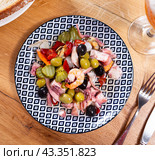 There is portion of seafood tapas salpicon with green and black olives on plate. Стоковое фото, фотограф Яков Филимонов / Фотобанк Лори