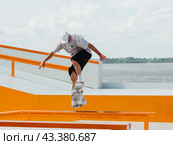 Young man doing jump trick on skateboard. Стоковое фото, фотограф Ольга Сергеева / Фотобанк Лори