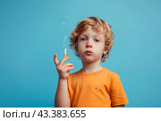 Мальчик в желтой футболке с сигаретой на голубом фоне. Стоковое AI-изображение, AI-художник Щеголева Ольга / Фотобанк Лори