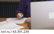 Engrossed in study student sits with laptop papers highlighting key points with yellow marker. Highlighting by yellow marker comprehension aids in retaining crucial information Highlighting articles. Стоковое видео, видеограф Olesia Kondrateva / Фотобанк Лори