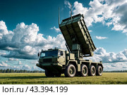 Modern air defence radar of military mobile missile launcher system of green color at blue cloudy sky background. Air defense installation outdoors. Concept of modern army industry. Copy ad text space. Стоковое AI-изображение, AI-художник Aleksandr Golubev / Фотобанк Лори