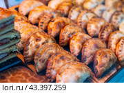 Appetizing savory empanadas showcased on countertop display. Стоковое фото, фотограф Яков Филимонов / Фотобанк Лори