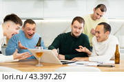 Happy male friends exulting after successful virtual investment. Стоковое фото, фотограф Яков Филимонов / Фотобанк Лори