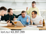 Happy male friends exulting after successful virtual investment. Стоковое фото, фотограф Яков Филимонов / Фотобанк Лори