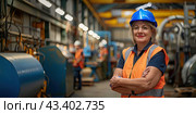 An elderly female foreman stands against the background of the workshops wearing a protective helmet and smiles. Copy space. Стоковое AI-изображение, AI-художник Ярославский Максим / Фотобанк Лори