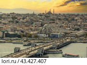 ISTANBUL, TURKEY - OCTOBER 12 ,2021: Istanbul city view from Galata tower in Turkey. Golden Horn bay of Istanbul and view on mosque with Sultanahmet district and Galata Bridge against sunset sky. Редакционное фото, фотограф Павел Муравьев / Фотобанк Лори
