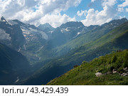 View of the Alibek Gorge, the Alibek River and the mountains of the Main Caucasian Ridge, opening from the upper station of the cable car system of the Dombay ski resort, Karachay-Cherkessia, Russia. Стоковое фото, фотограф Ula Ulachka / Фотобанк Лори