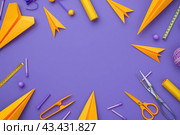 Back to school, business office education concept. Assortment of Yellow colors supplies, crayons, plane, pens, paper airplane on a table. Copy space Purple background, flat lay overhead. Workspace. Стоковое AI-изображение, AI-художник Марина Демидюк / Фотобанк Лори