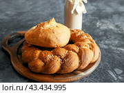 Assortment of white bread. Kalach and challah made of wheat flour on table with milk. Copy space. Стоковое фото, фотограф Оксана Медведева / Фотобанк Лори