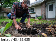 A man checks the septic tank on his property. Filling and pumping out septic tanks. Стоковое AI-изображение, AI-художник Коханова Наталья / Фотобанк Лори