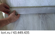 The master finisher installs a plastic baseboard, snapping it into the grooves. Home renovation. Стоковое видео, видеограф Дмитрий Кобзев / Фотобанк Лори