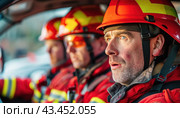 A team of firefighters, clad in red uniforms, is sitting inside a vehicle on standby. Стоковое AI-изображение, AI-художник Юрий Поздников / Фотобанк Лори