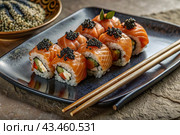 Japanese food. Sushi rolls California, Philadelphia with eel, red caviar and salmon. The concept of the sushi bar menu. Стоковое AI-изображение, AI-художник Photojuli / Фотобанк Лори