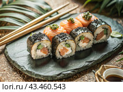 Japanese food. Sushi rolls California, Philadelphia with eel, red caviar and salmon. The concept of the sushi bar menu. Стоковое AI-изображение, AI-художник Photojuli / Фотобанк Лори