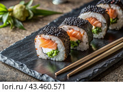Japanese food. Sushi rolls California, Philadelphia with eel, red caviar and salmon. The concept of the sushi bar menu. Стоковое AI-изображение, AI-художник Photojuli / Фотобанк Лори